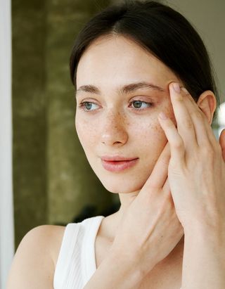 Woman massaging her face